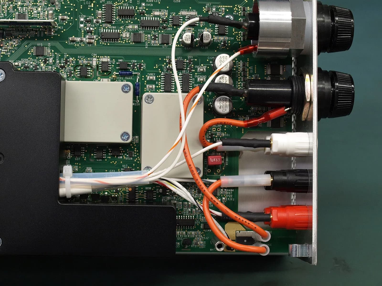 A bench multimeter with its display lit, seen from the front